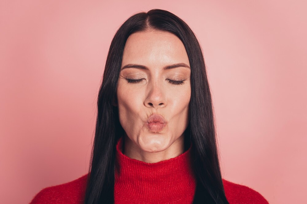 portrait-cute-girl-casual-outfit-blowing-kiss-with-pout-lips-pink-background_525549-991.jpg